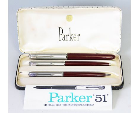 A Parker 51 fountain pen and roller ball pen set, in steel and Burgundy (the fountain pen un-inked), in original box, with a 