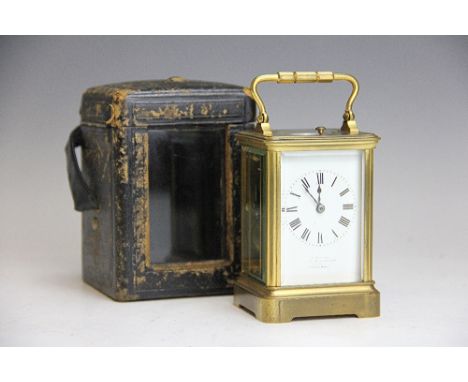A late 19th century French gilt brass repeating carriage clock, the white enamel dial with Roman numerals (indistinct retaile
