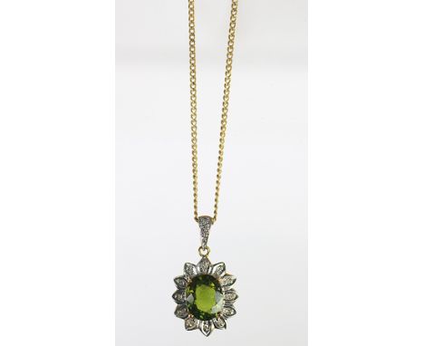 A 'Cuprian Tourmaline' and diamond pendant set in 9k yellow gold, the oval shaped tourmaline (untested) within a surround of 