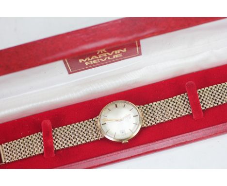 A gentleman's 9ct gold Marvin Revue wristwatch 1978, the circular silvered dial with batons, centre sweep seconds and date ap