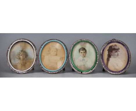 A set of four enamel and paste set portrait miniature frames, late 19th/early 20th century, each oval white metal frame with 