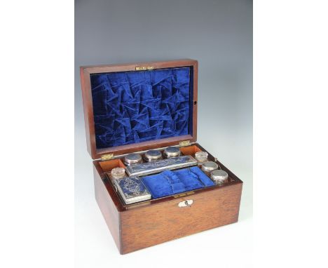 A Victorian rosewood dressing case, with mother of pearl escutcheon and enclosing blue velvet lined fitted interior, lift-out