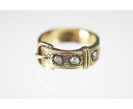 A Victorian diamond set mourning ring, the belt ring set with three old cut diamonds, engraved to the interior 'Francis Mills
