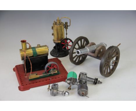 A brass and iron vertical live steam engine, 19cm, a copper and painted metal live steam engine, 21cm long, a model air craft