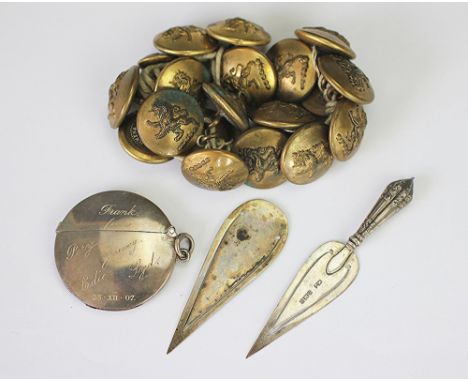 A silver page marker in the form of a trowel, Birmingham 1900, and another lacking handle, a silver circular vesta, Chester 1