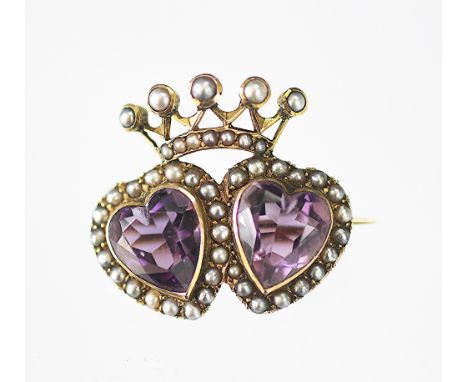 A Victorian amethyst and seed pearl set sweetheart brooch, designed as two amethyst carved hearts within a seed pearl surroun
