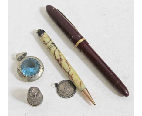 A pendant set with a blue stone marked '925', a hallmarked silver thimble and scorpio pendant marked 'silver', a vintage pen 