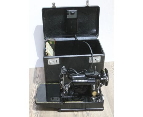 A Singer sewing machine 222K in hard case, with power lead and original manual Appears to be in good condition, with paintwor