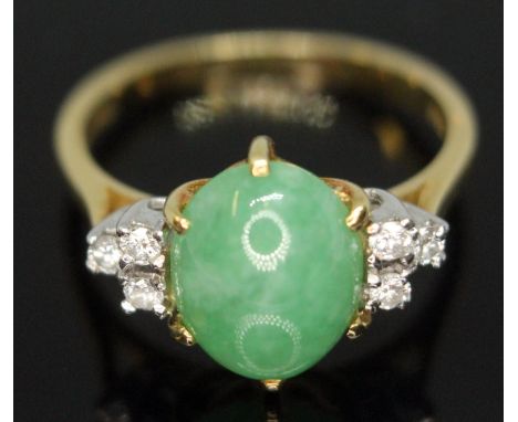 A diamond and jade cabochon ring, the central jadeite jade cabochon measuring approx. 9mm x 8mm x 4mm, hallmarked 18ct gold, 