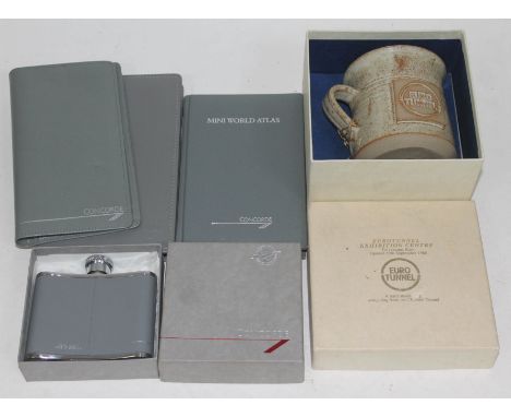 Concorde memorabilia comprising a hip flask, an atlas, a note pad and an address book, together with a Euro Tunnel mug.  