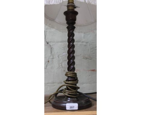 A 1920s twist oak table lamp with shade, height 57cm.  