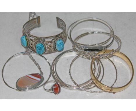 A mixed lot including silver bangles, an eastern bangle set with 'scarab beetles', a rolled gold bangle, a ring set with band