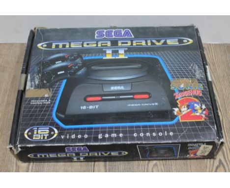 A Sega Megadrive II, in original box, with 2 controllers and power lead. Box also includes original manual and 4 games, The L