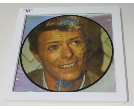 A signed, framed 12" picture disc David Bowie - Rare interview, with ticket stubs and first day cover  isc and frame appear i