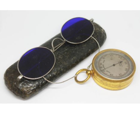 A 19th century git brass cased pocket barometer signed 'Sewill Liverpool' and a pair of blue lens spectacles with case.  