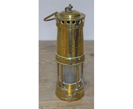 A brass miner's lamp, 'Thomas &amp; Williams Ltd Aberdare  Alderman W Healey J.P. Heywood', height (including hook) 30cm.  