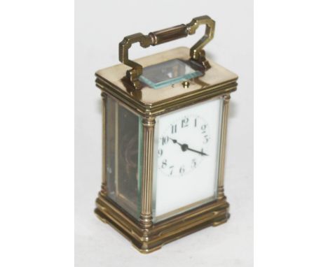 A brass carriage clock, height 15cm.  Condition - not currently running.
