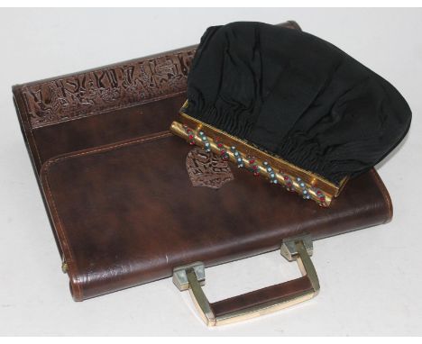A vintage clutch bag, the gilt metal handle set with blue and red cabochons, together with an embossed leather satchel.  