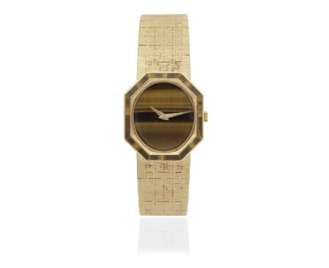 Piaget. A lady's 18K gold manual wind bracelet watch with tigers eye dial and bezelReference: 9341 A6Date: Circa 1980Movement