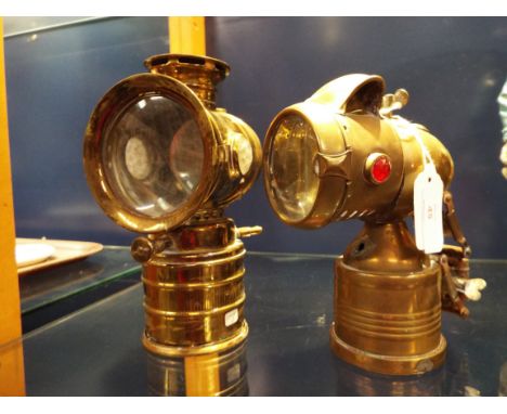 A brass carbide bicycle lamp monogrammed 'CH' together with another similar