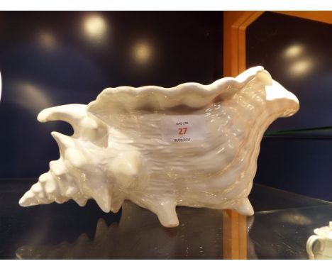 A white glazed ceramic planter in the form of a conch shell