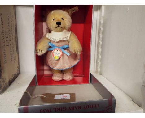 A boxed Steiff 'Teddy Bear Girl 1930 Blond 25' replica 1993 having plush mohair and wearing damask clothes, button to ear No 