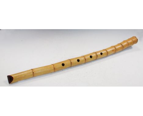 A bamboo recorder style whistle, the open ends red lacquered, four finger stops pierced into its length, 59.5cm (23.5 in) lon
