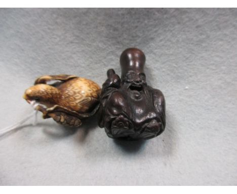 Anraku, a 19th century marine ivory netsuke together with a wood netsuke depicting Fukurokuju, the first carved as a quail wi