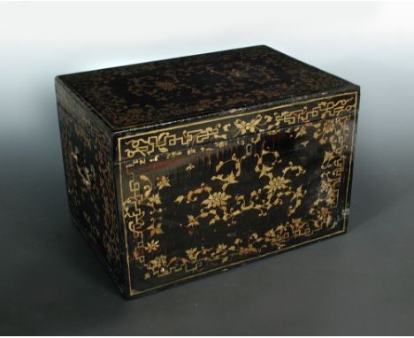 A 19th century black lacquer tea caddy, the rectangular hinged lid gilt with lotus scrolls, the interior with two pewter cani