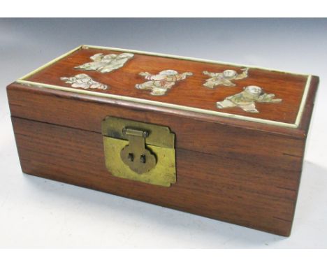 A hardwood jewellery box inlaid with mother of pearl, the rectangular hinged lid with six children playing blind man's buff, 