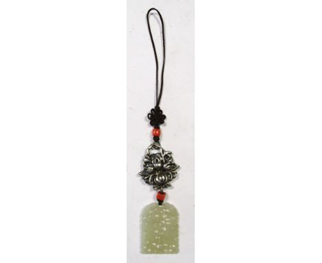 A late 19th/early 20th century nephrite jade pendant pierced and carved within the round arch outline with two children among