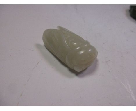 A nephrite jade cicada pendant carved from an evenly pale green stone, the suspension loop drilled through the mouth, 4.5cm (