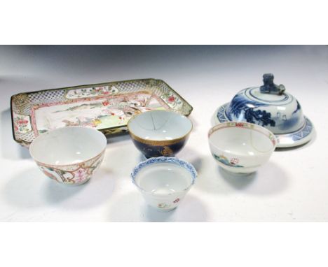 An 18th century enamel tray, four tea bowls and a blue and white cover, the tray painted with an equestrian departing a pavil