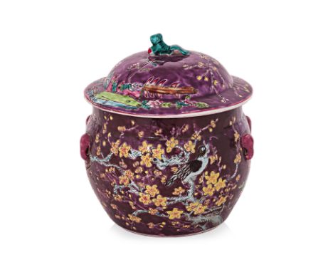 A LARGE PURPLE GROUND PORCELAIN JAR AND COVER
Circular jar and cover decorated in flowering plum blossoms and other flowers, 