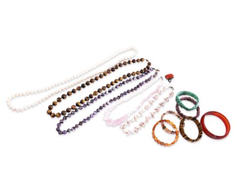 A GROUP OF COSTUME JEWELLERY
Comprising of two pearl necklaces, an Art Deco carnelian set silver ring, amethyst and tigers ey