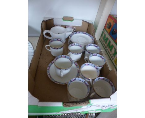 Eight cups and saucers in floral and gilt pattern on white ground