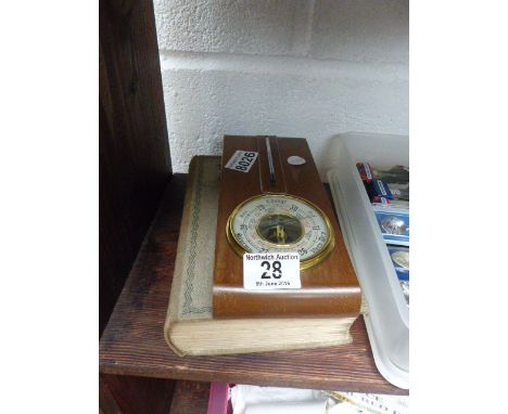 Book of needlecraft and small barometer