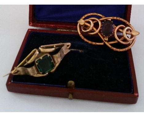 Two Gilt Mounted Brooch; one set with an amethyst.  