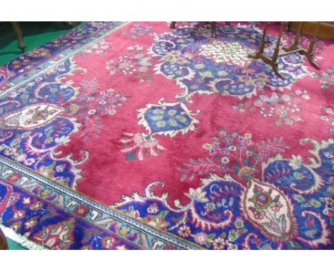 A Red Ground Persian Tabriz Carpet, 327 x 225cm.