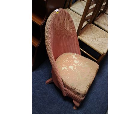 A LOW LLOYD LOOM CHAIR