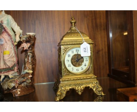 A 20TH CENTURY GILT METAL MANTEL CLOCK, of square form, the circular dial with Arabic numerals, outer minute track and centra