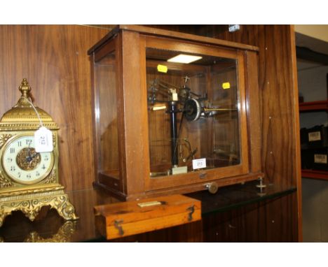 A SET OF BAIRD AND TATLOCK GLASS CASED VINTAGE SCALES AND WEIGHTS