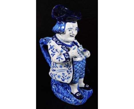 A Dutch Delft model of a snuff taking Toby jug, decorated in blue and white. 28cm H.