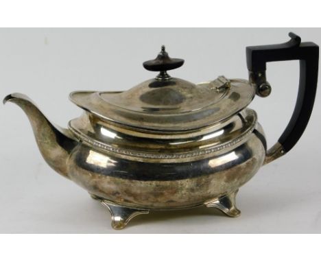 A  George V silver teapot, by Elkington &amp; Co. of squat baluster form, with ebonised handle and knop finial on splayed fee