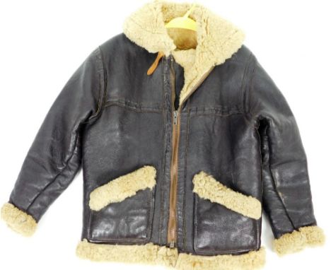 An early 20thC dark leather flying jacket, with wool interior and metal zip, size unknown.