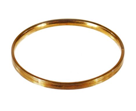A 9ct gold bangle, partially engine turned, 7g, 9cm Dia.