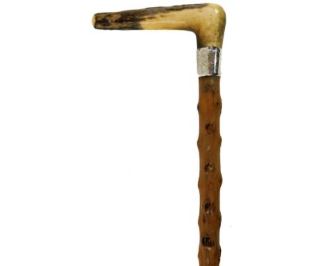 An antler handled walking stick, with silver collar and rubber end, the collar 1916, 81cm H.