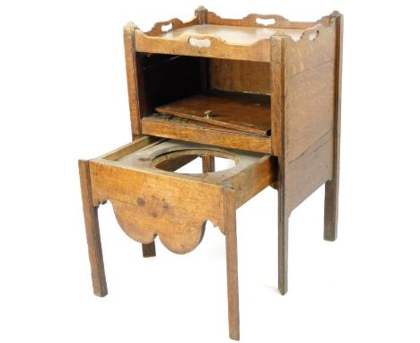 A George III oak night commode, with a carved and pierced gallery above a fall front and pull out commode on block stiles, 85