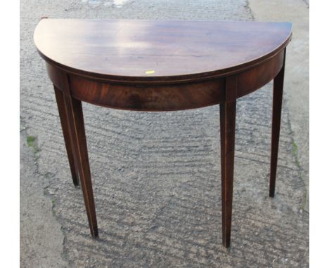 A George III mahogany semicircular fold-over top card table, on square taper supports, 36" dia x 30" high 