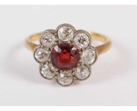 A Victorian yellow metal, diamond and red stone cluster ring, size J, 2.9g 